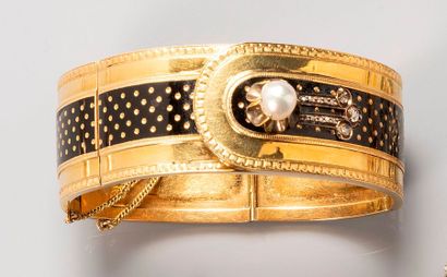 null Bracelet rigide articulé en or jaune 18k (750) à décor émaillé noir rehaussé...