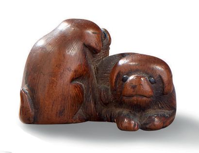 JAPON XIXE SIECLE Netsuke en bois sculpté représentant deux chiots jouant, les yeux...