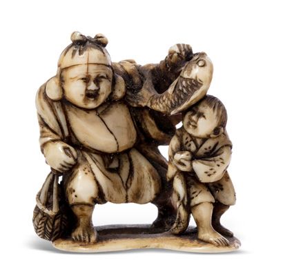 JAPON 
Deux netsuke en ivoire rehaussé de brun, l'un figurant un Kirin assis, la...