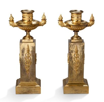 null PAIRE DE FLAMBEAUX en bronze ciselé doré formé d'une urne à deux flammes aux...