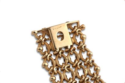 CARTIER Bracelet "résille" or jaune 18k (750).
Vers 1950. Signé et numéroté.
Long.:...