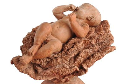 null Sculpture en terre cuite à  l'image d'un nourrisson reposant sur un choux. Signature...