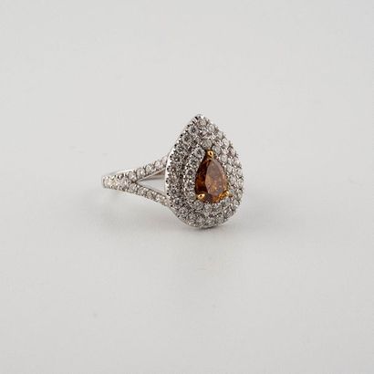 null 750°/00 white gold drop shaped ring set with a Fancy "Yellowish Orange" pear...