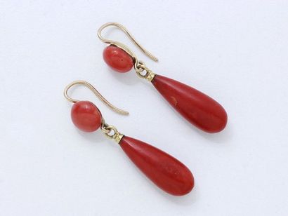  Pair of 750 thousandths gold earrings, holding a drop of coral in pendants, the...
