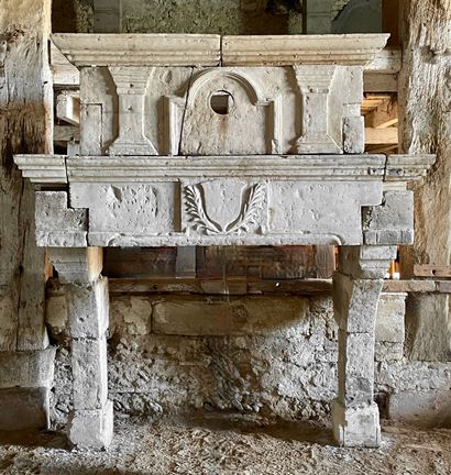  Stone Louis 13 mantel. 
Lintel adorned with a central escutcheon. 
Mantel decorated...