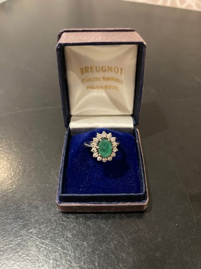White gold ring set with an emerald in a...