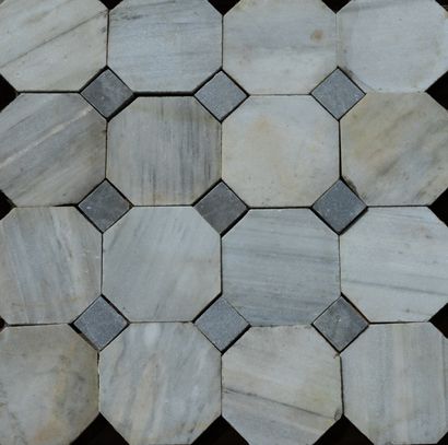  Octagonal paving. 
In veined white marble and cabochons in grey shaded marble. 
Late...