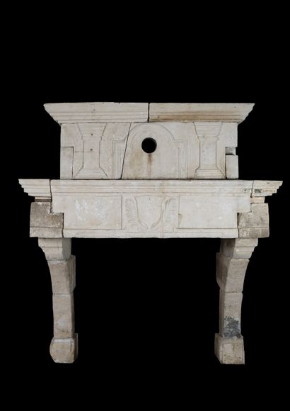  Louis 13 stone mantel. 
Lintel decorated with a central escutcheon. 
Mantel decorated...