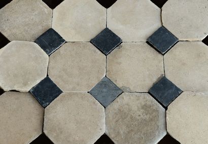  Stone paving. 
Octagonal format, in beige limestone, with black marble cabochons....