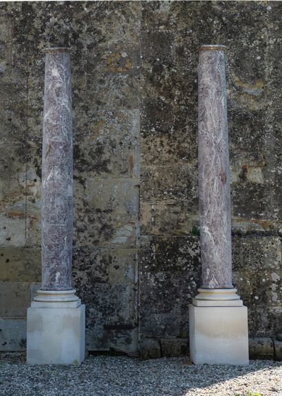  Pair of columns in Doric style. 
The monolithic shaft resting on a cubic base. 
Red...