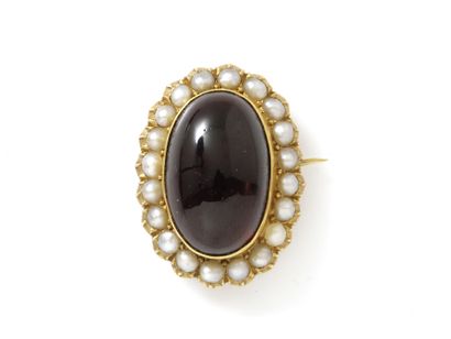null Brooch in gold 750 thousandths dressed with a cabochon of garnet in closed setting...