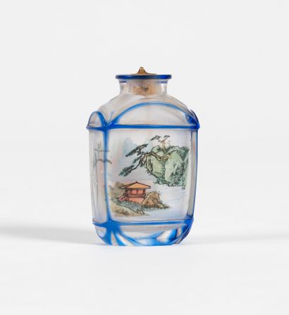 null A snuffbox in blue overlay glass. Painted inside with a decoration of landscape,...