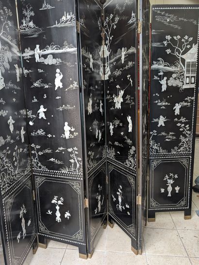 null black lacquered wood screen decorated with children's games.
Six panels.China.Modern...
