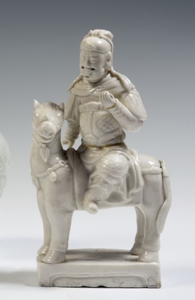 null 
China 
Two Chinese-white porcelain figures of Guandi, one sitting on a horse,...