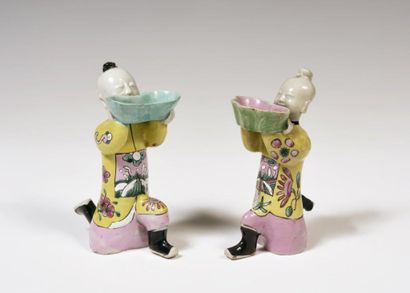null 
China

Pair of porcelain cups formed of children, one knee on the ground, holding...