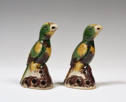 null 
China

A pair of green, brown and ochre enamelled parrots standing on pierced...