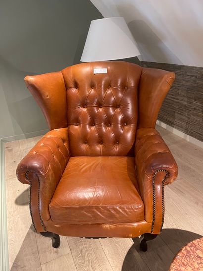 null Pair of tan leather armchairs with ears and cambered legs