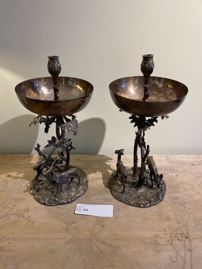  Two silvered bronze candlesticks with brocade decoration on a mound, the branch...