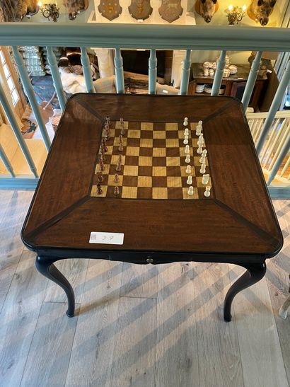 null Black patinated wood game table opening with two drawers in the belt, top decorated...
