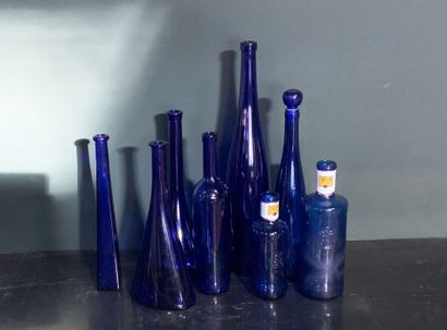 Eight blue glass bottles and or carafes