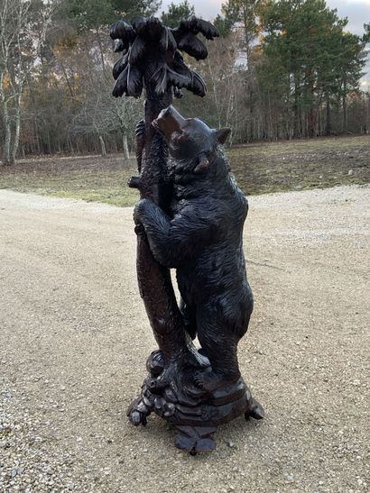 null Carved wooden bear standing holding a tree 

Work of Brienne

H : 147 cm