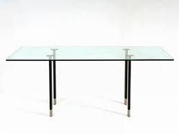 ANONYME- FONTANA ARTE- 1980 
Table à plateau rectangulaire en verre et quatre pieds...