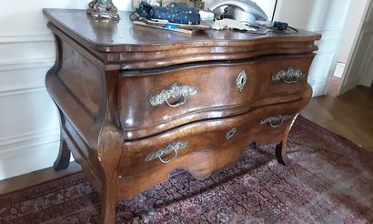 null 
A walnut and stained fruitwood marquetry chest of drawers with a slightly curved...
