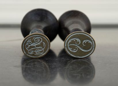 null Lot of two blackened wood seals and a silver plated metal seal, figured.
