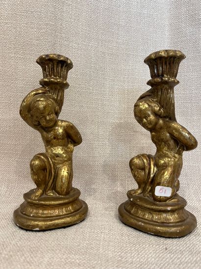 null A pair of gilded wood candlesticks featuring putti.
Height: 22 cm
