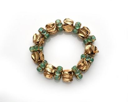 null Bracelet articulé en or (585 millièmes) à motifs de palmes alternées de cabochons...