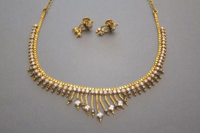null Set including a drapery necklace and a pair of yellow gold earrings adorned...