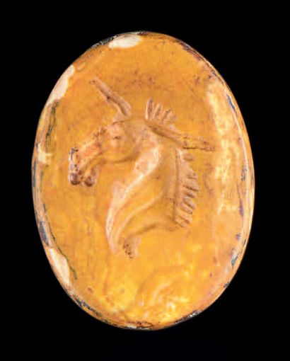 null Flat oval intaglio engraved with a mule's head on the left. Yellow jasper. Roman...