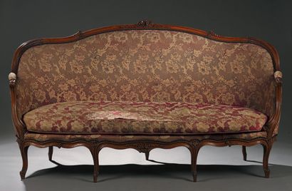 null Moulded and carved beechwood sofa with a basket back, the moving belt with foliage...