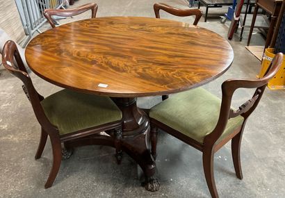 null Circular mahogany dining table on a baluster shaft with cut sides resting on...