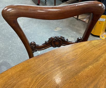 null Circular mahogany dining table on a baluster shaft with cut sides resting on...