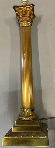 null A gilt bronze and chased lamp stand on a square base, fluted shaft, Corinthian...