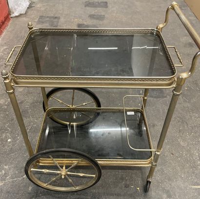 Gilt brass side table with two wheels and...