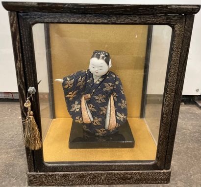 Japanese doll in a glass and wood cage 

26...