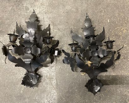  Pair of black patina wrought iron sconces with three lights and stylized flowers....