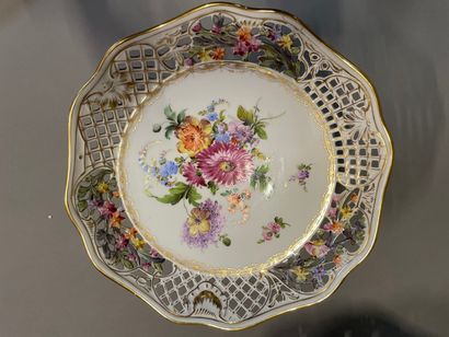 null A Dresden openwork porcelain basket, two display stands and a cup with flowers.

19th...
