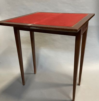 A mahogany veneered game table with brass...