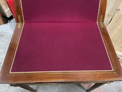 null A mahogany veneered game table inlaid with brass fillets, tapered legs with...