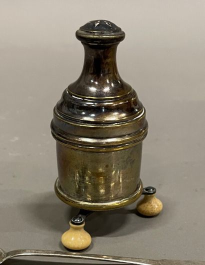 null A silver-plated pepper pot on three turned ivory feet, 19th century.

H. 11...