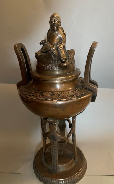 A patinated bronze incense burner, the lid...