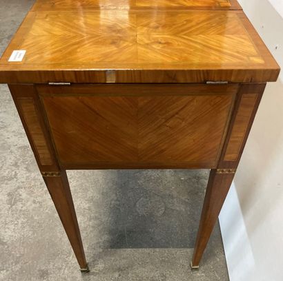 null Veneered chest of drawers inlaid with green tinted fillets, the top opening...