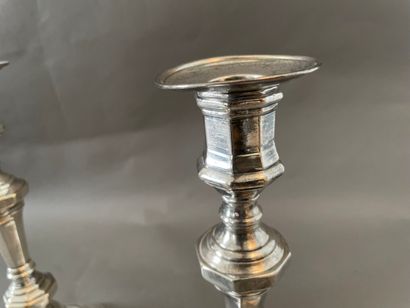 null Pair of silver plated candlesticks, octagonal base with steps, baluster shafts.

H...