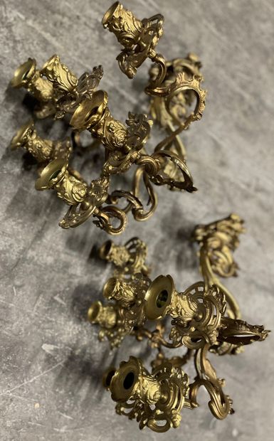 null A pair of ormolu sconces with six scrolled lights and openwork foliage.

Middle...