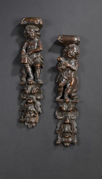 null 
*Pair of carved wood sconces representing naked children, standing on a leafy...