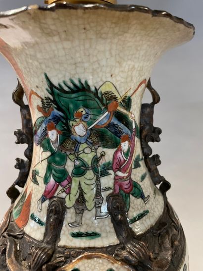 null A Nanjing porcelain baluster vase with a battle scene on a cracked background...