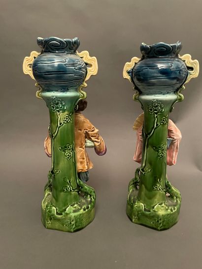 null 
Pair of barbotine vases decorated with two Chinese leaning against a column...